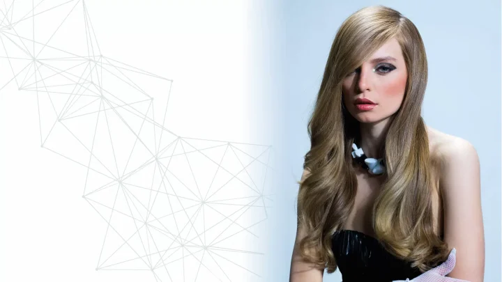 Woman with long, wavy blonde hair wearing a black strapless top and white gloves, posing against a light background with geometric line patterns on the left side.
