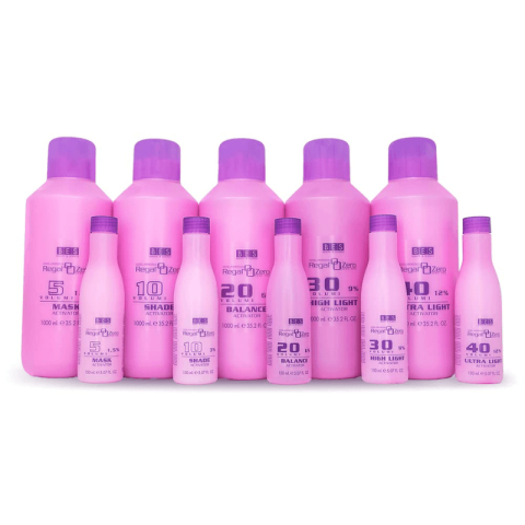 Nine pink and purple bottles of BES Regal Zero Activator hair products are arranged in two rows, each showing different volumes and numbered labels.