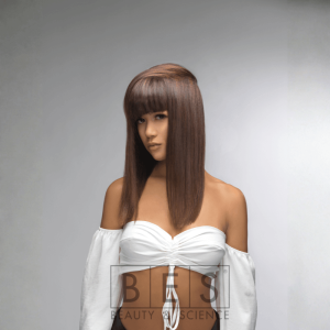 A woman with straight, medium-length brown hair and blunt bangs in an asymmetrical cut, styled with the Hi-Fi Salon Intro Kit, wears a white off-shoulder top against a plain light background. BES logo appears at the bottom.