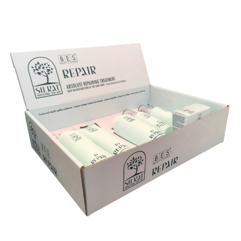 Open box displaying the Silkat Repair Try Me Kit hair care products, with bottles and packaging visible. Branding is shown on the lid and front of the box.